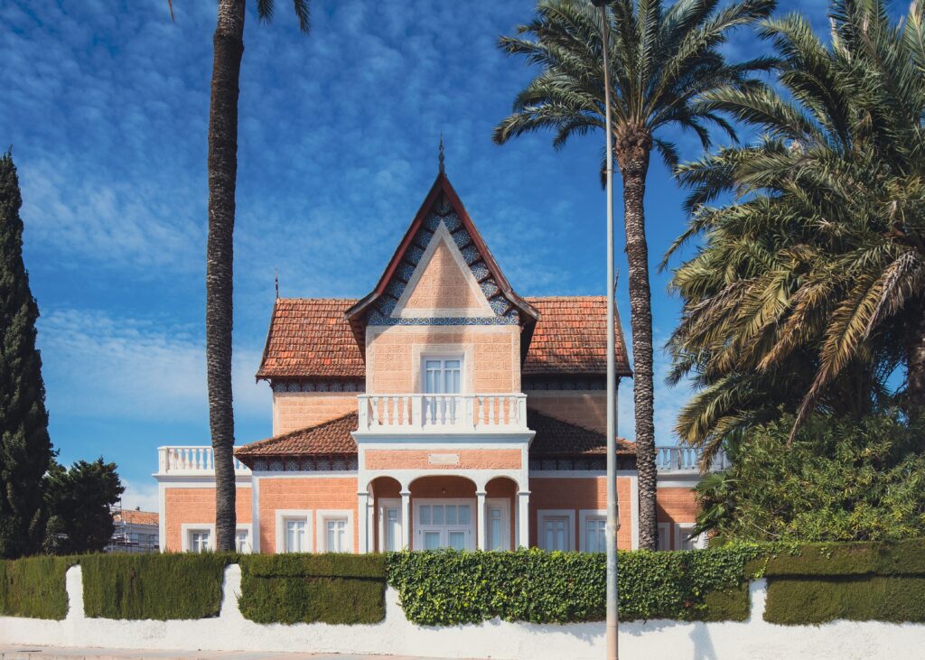 Colonial-style villa surrounded by palm trees in sunny San Javier, Spain.