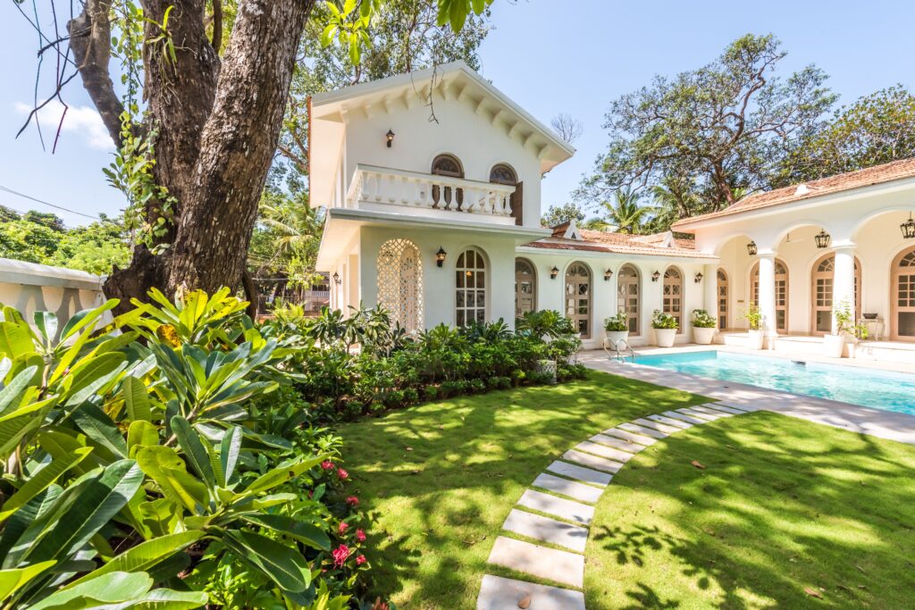 Charming villa surrounded by lush garden and pool, ideal for luxury living.
